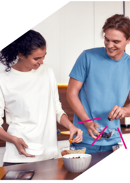 a man and woman making breakfast with oats