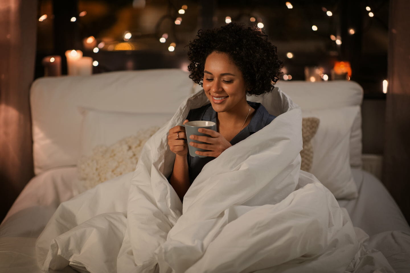 women enjoying a warm drink in bed