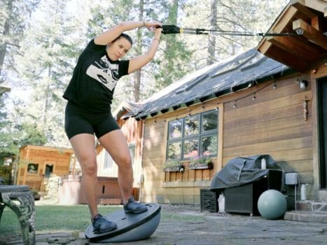 Woman working out on a balance board outdoors