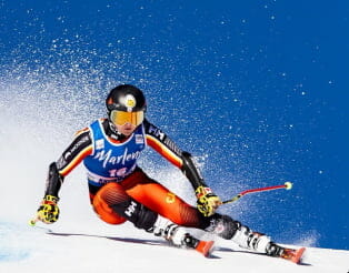 Professional skier leaning into a turn