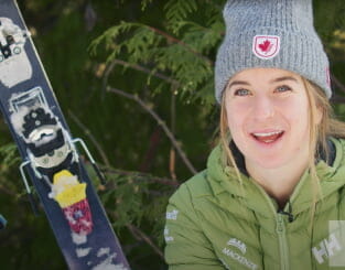 Smiling woman outdoors with skis